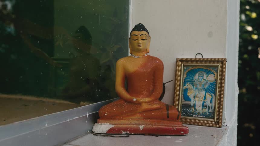 Religious ceramic doll on the window outside