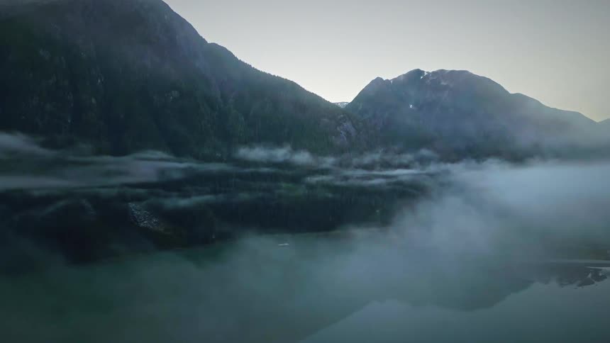 Misty lake on the edge of a mountain