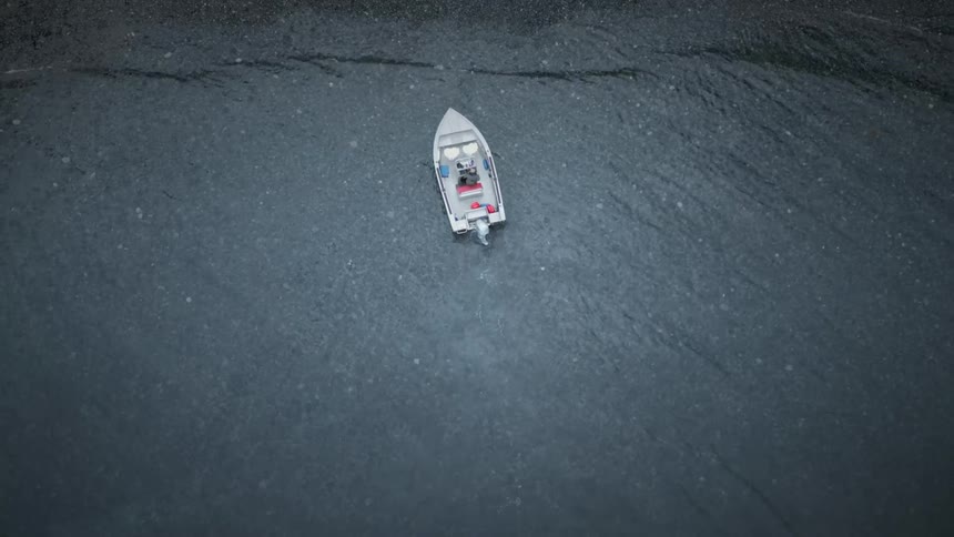 The boat is floating in the water below