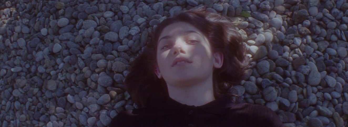 A girl is laying on the rocks