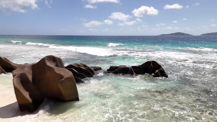 Landscape of a tropical beach with mountains on the horizon