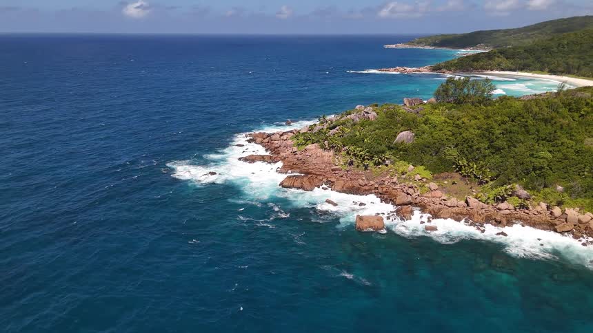 Forested tropical island surrounded by turquoise sea