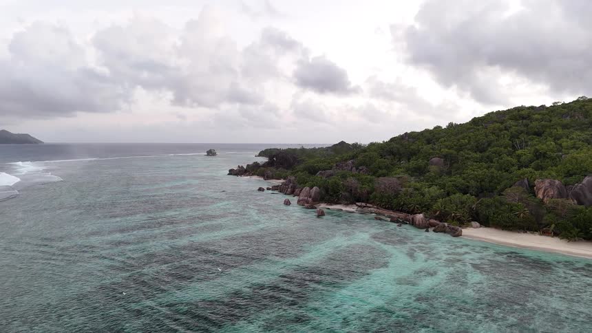 Birds flying in an archipelago with turquoise blue sea