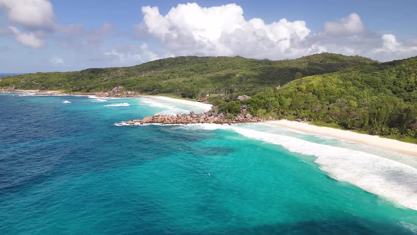 Aerial of tropical beach with pristine sandy shoreline and turquoise water