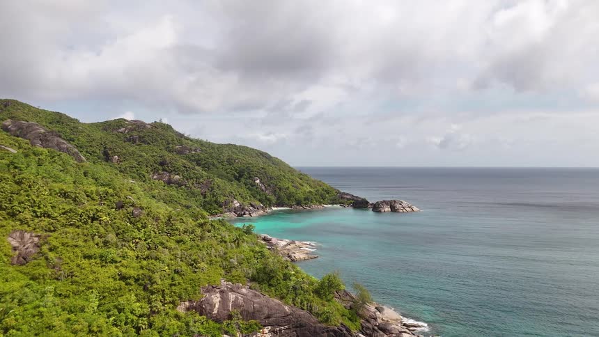 Aerial landscape of forested mountains by the sea
