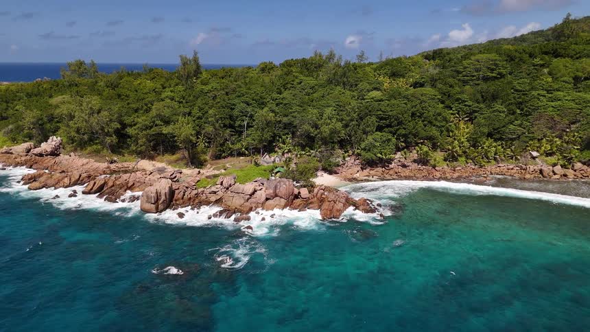 Turquoise blue sea on the edge of the wooded coast