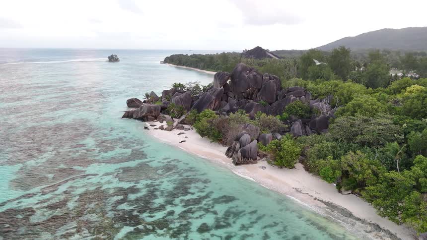 Aerial of tropical beach with sandy beach and crystal clear turquoise water