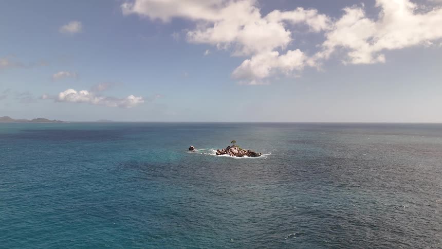 In the long blue waters is a single tiny island