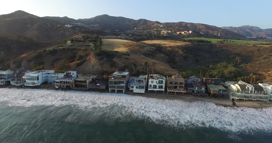 Houses in a seaside setting with mountains in the background in Malibu, California