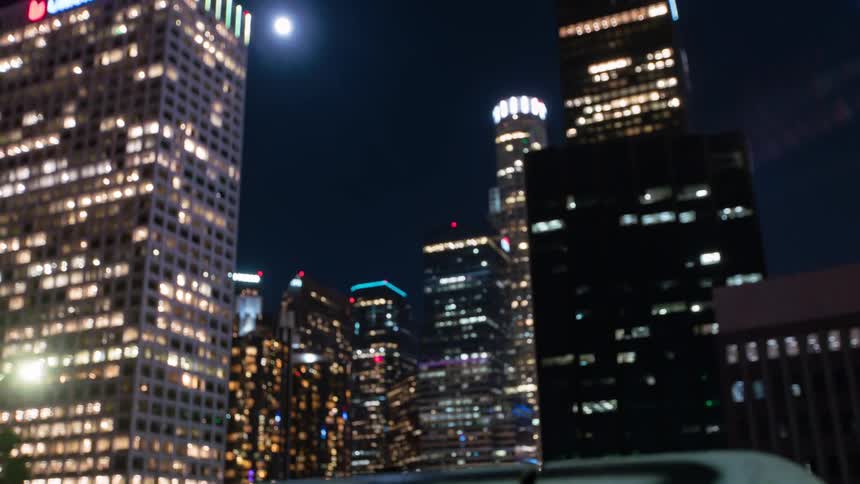 Viaduct on the edge of a metropolis with modern skyscrapers seen at night in downtown Los Angeles