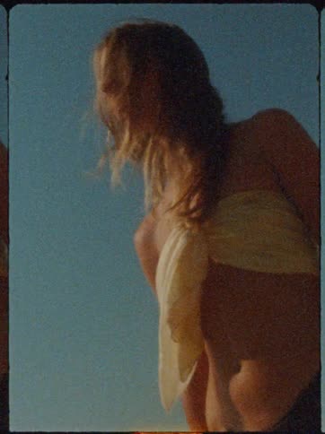 Blonde woman outdoors with her hair moving in the wind