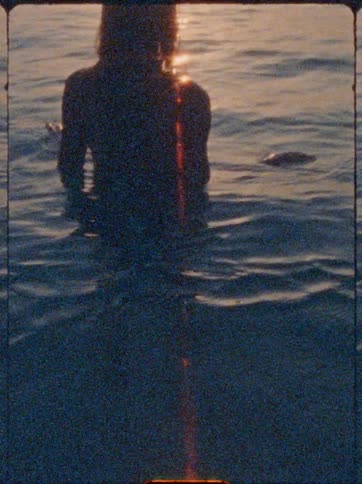 Woman enjoying the sea in the late afternoon