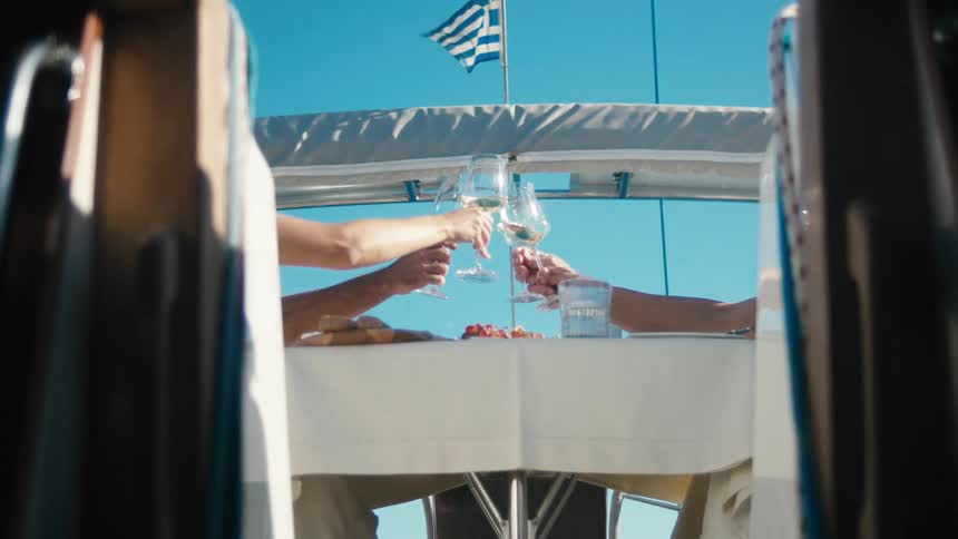 People toasting glasses of wine on a yacht