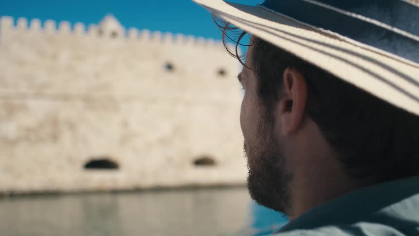 A man is looking over at the castle