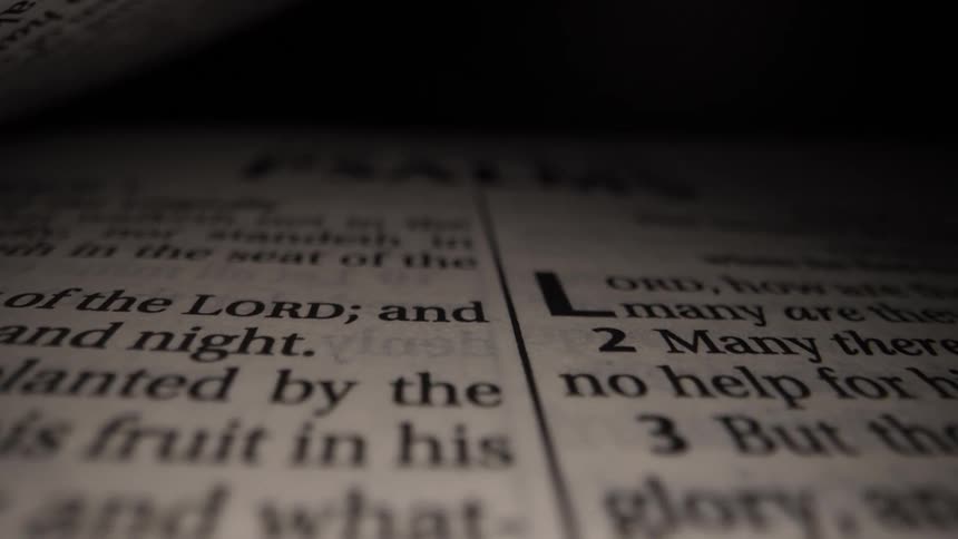 Close up of the book of psalms half opened to page on scriptures and versus