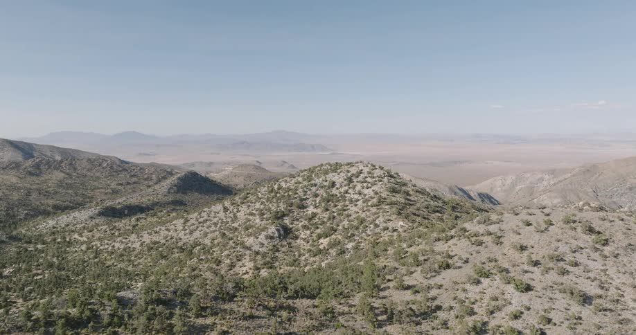 Scenery of mountains with sparse vegetation against a blue sky