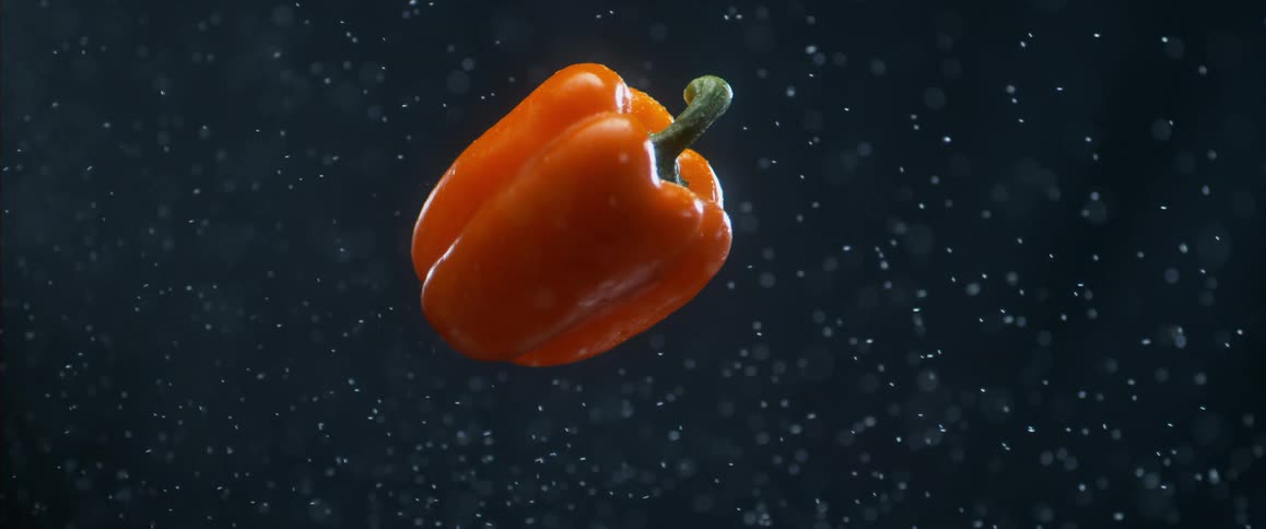 Close up of a hand throwing a pepper