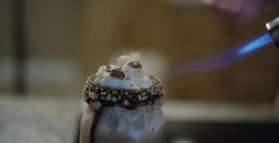 Smores milkshake being torched to toast the marshmallows on top