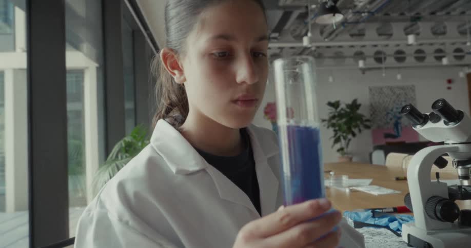 A scientist shakes liquid in a test tube