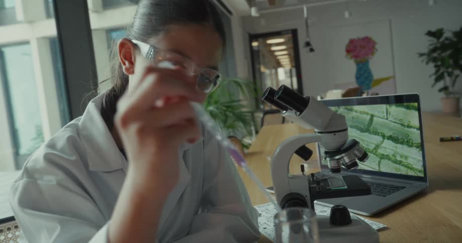 The girl uses a dropper in the lab