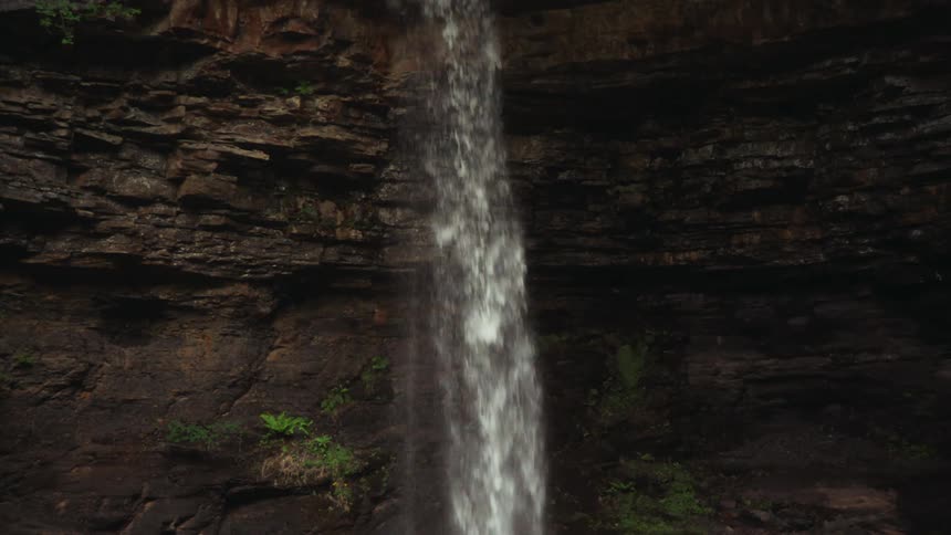 The waterfall pours down off a steep cliff