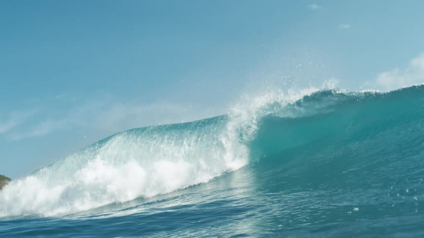Wave forming and breaking in a clear blue ocean