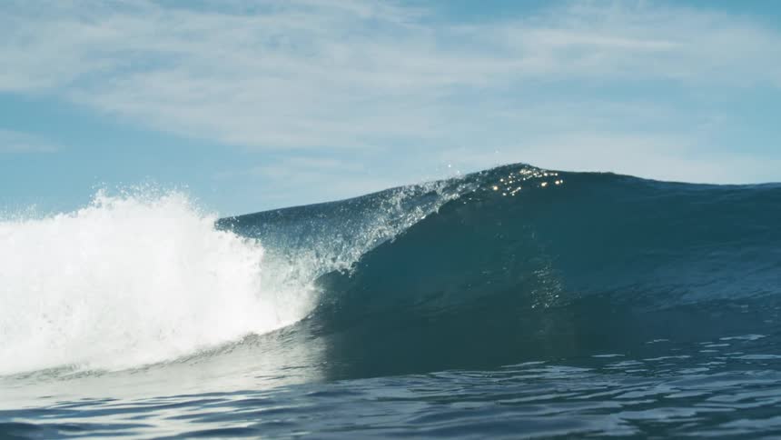 The wave moves and crashes in the ocean