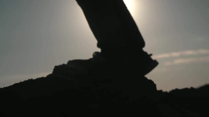 A person standing on top of a rock