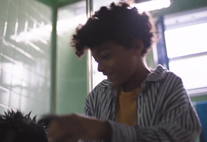 Dog being bathed in the bathroom shakes its wet coat and its owner smiles
