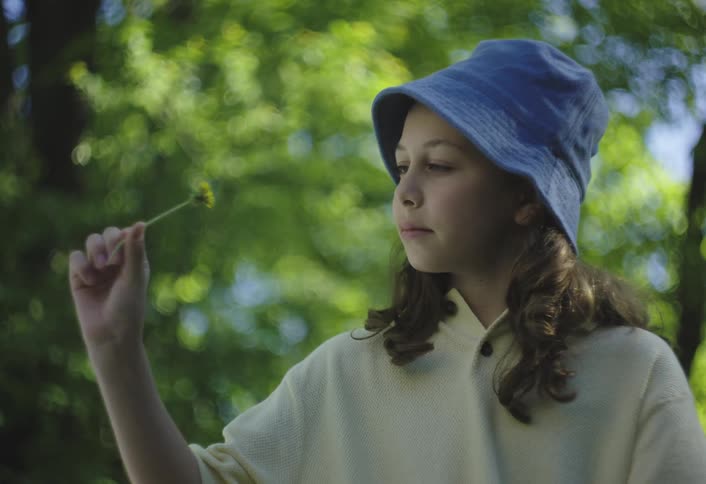 Girl smelling a yellow flower