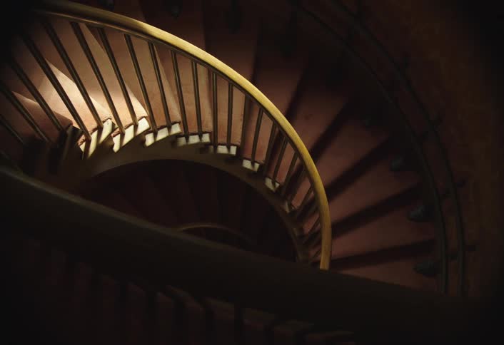 Two children move down the stairs together