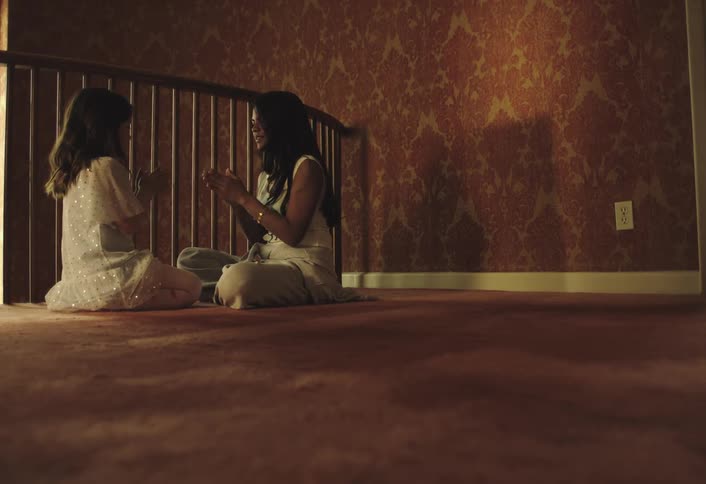 Two girls are playing patty cake together