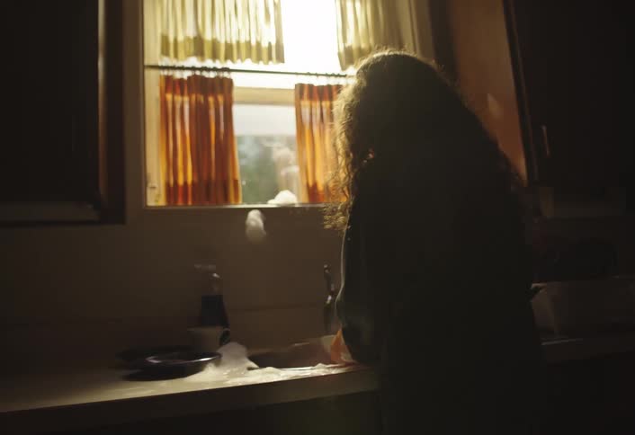 Girl washing a plate and dropping it
