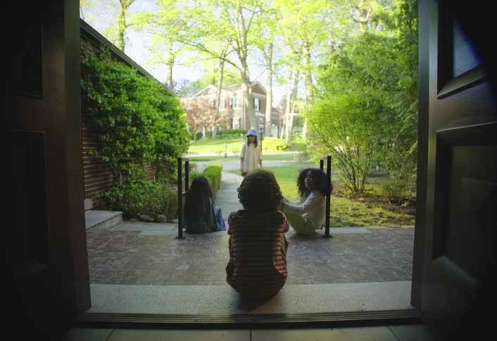Children talk together on the porch