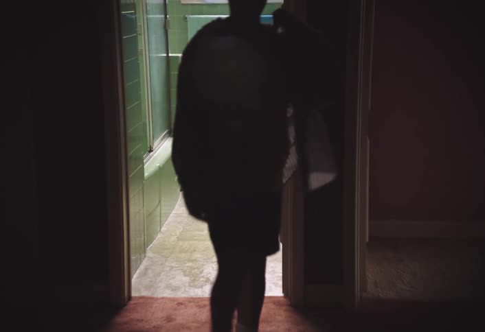 Boy coming out of the bathroom with a dog