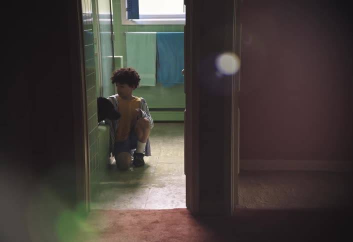 The boy has his dog in the bathtub