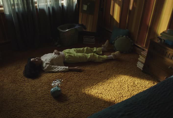 Girl lying on the carpet in a room of the house