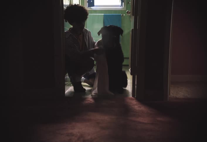 A boy towel dries his dog