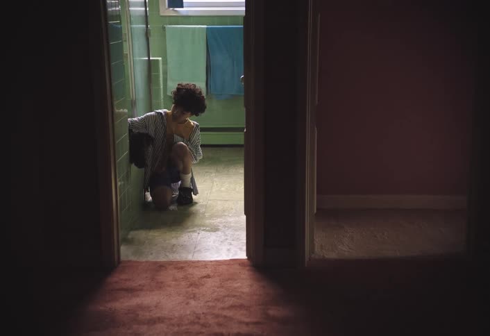 Boy in the bathroom bathing a dog