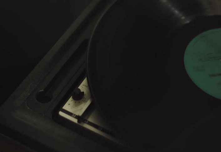 Vinyl record spinning on vintage music player