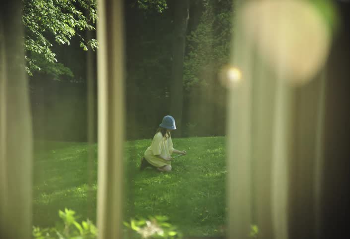 Person kneeling on grass gardening