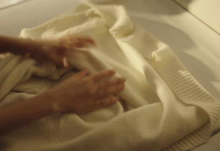 Boy smelling clothes and hanging them out