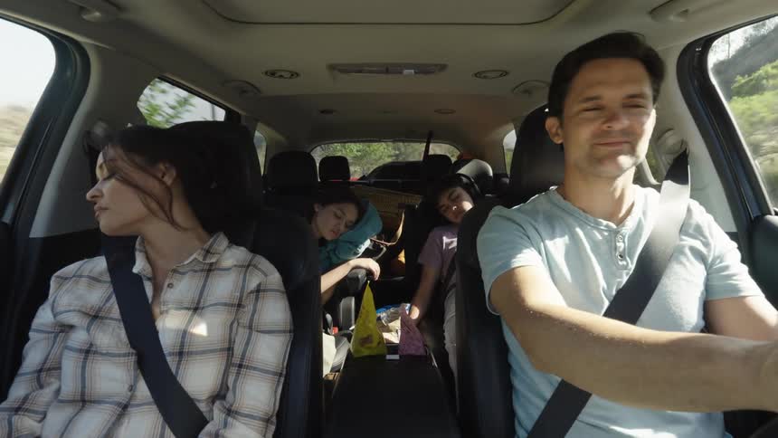 Man driving concentrated while his family is sleeping