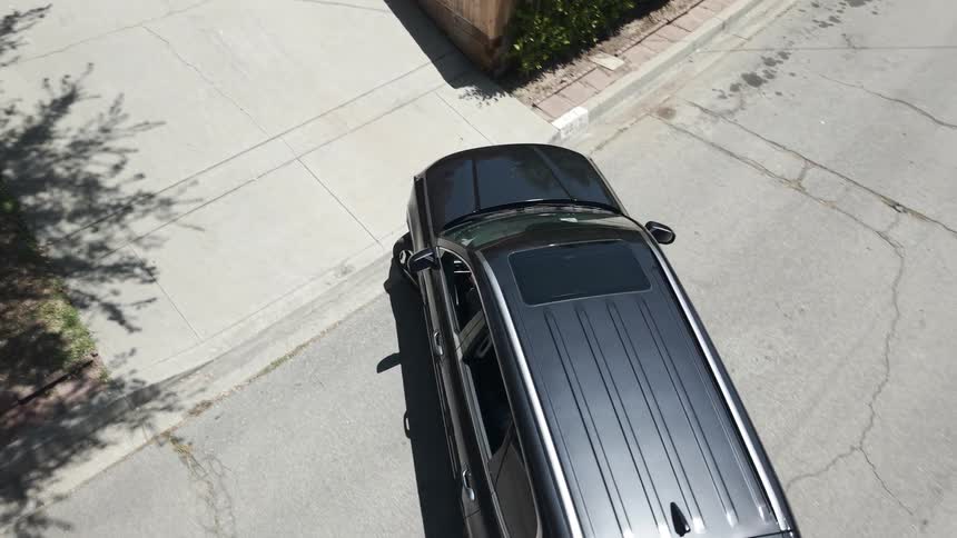 Black suv leaving a houses garage