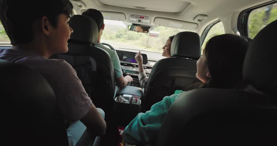 Family including two children on a trip inside the car