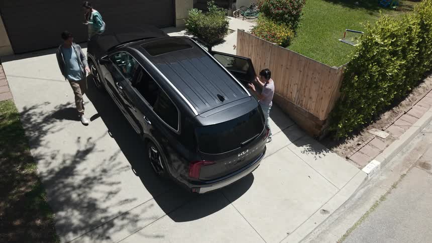 Family getting into a black suv car