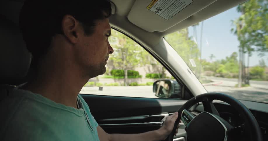 Man driving a car on a city road