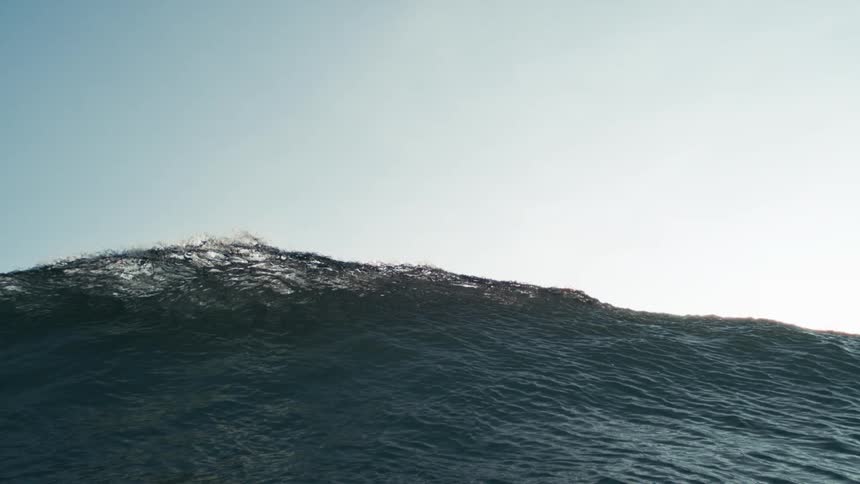 Heavy waves are causing the ocean water to rise and splash at midday