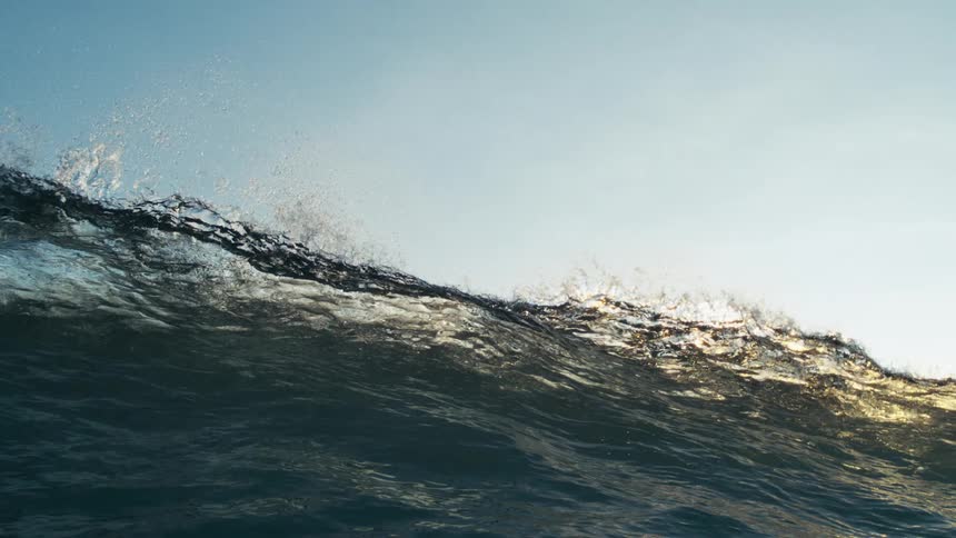 Heavy waves are causing the ocean water to rise and splash at midday