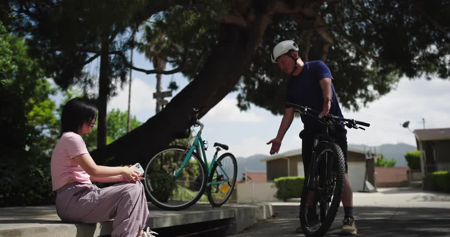 A father and daughter ride bikes together